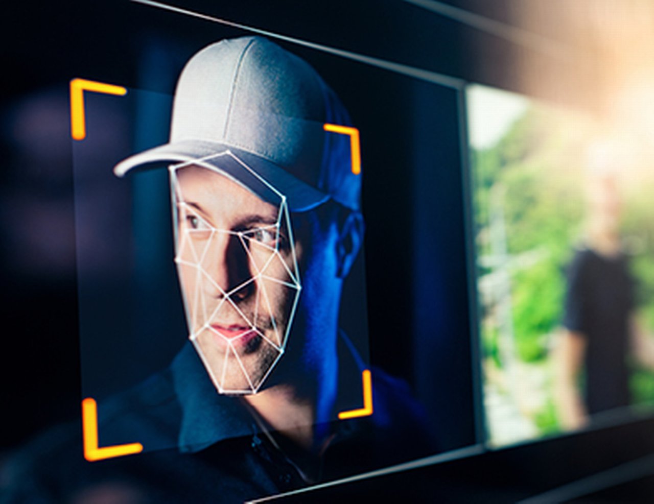 Face of a man wearing a baseball cap being analyzed by facial recognition software